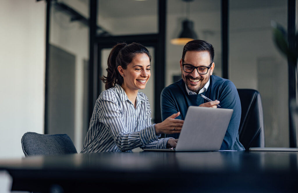 Smiling business people, looking at something over the laptop. Smiling business people, looking at something over the laptop.